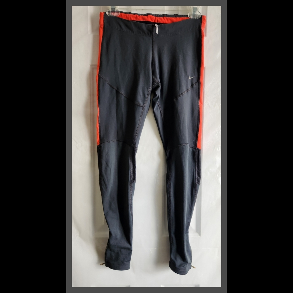Nike gray and salmon leggings with mesh + zipper details.